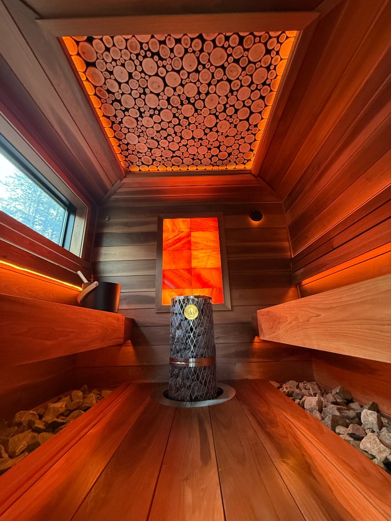 Handcrafted custom sauna interior with warm wood, ambient lighting, and artisanal detailing